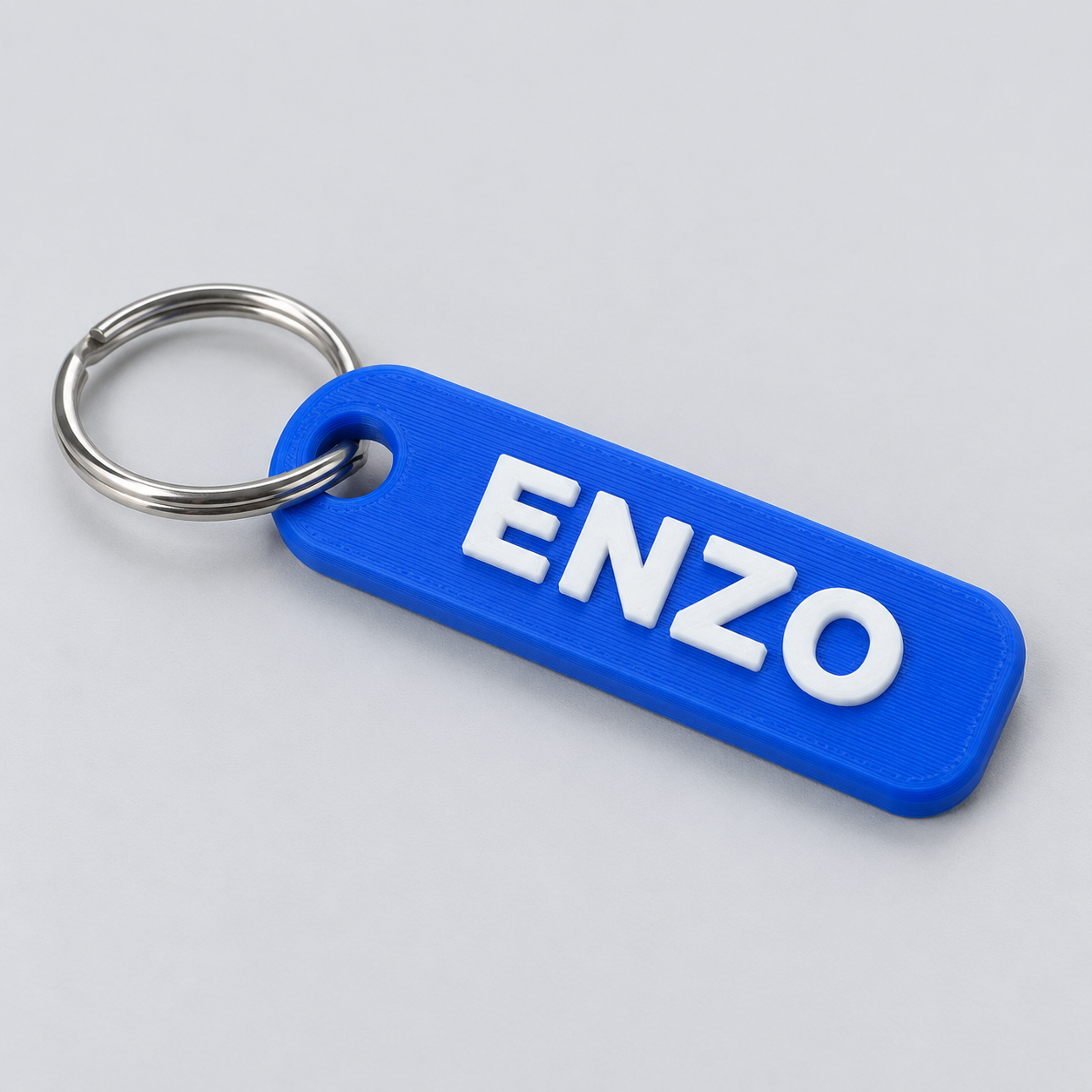 Illustrative blue personalized keychain with white lettering